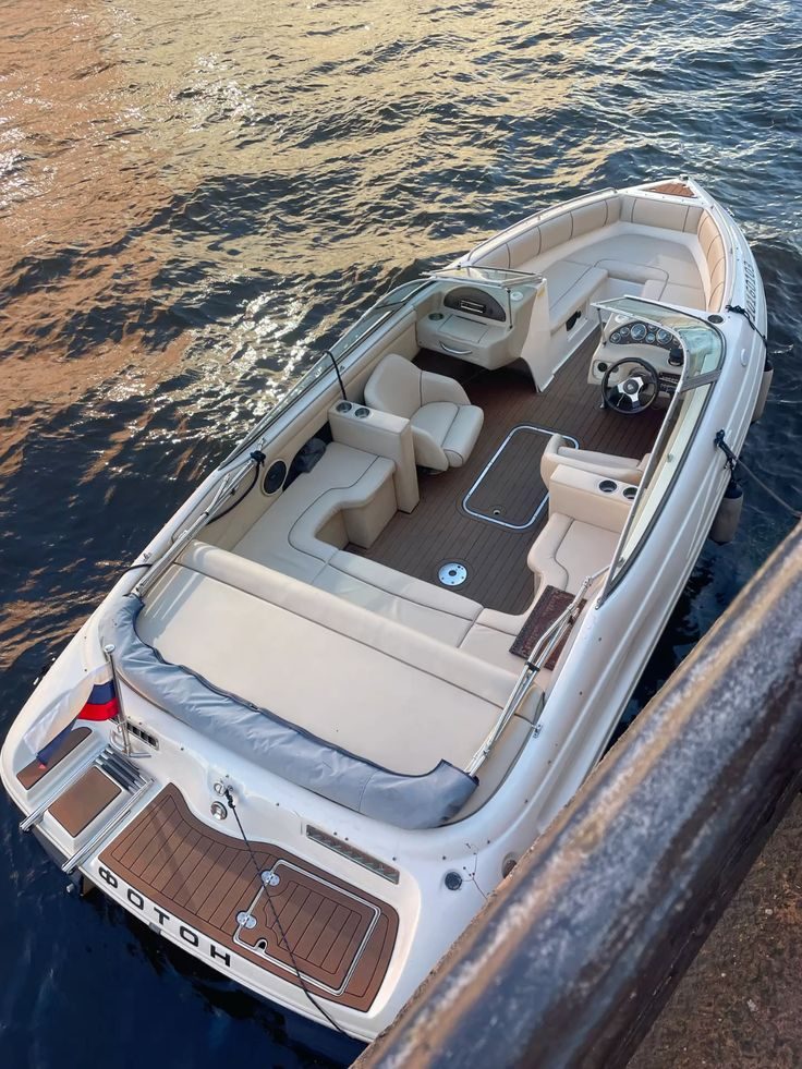 Clean speedboat on the water — pristine cream interior and polished exterior, ready for the lake