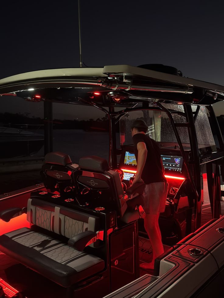 Fully detailed center console boat lit at night — ceramic-coated finish and ambient interior lighting