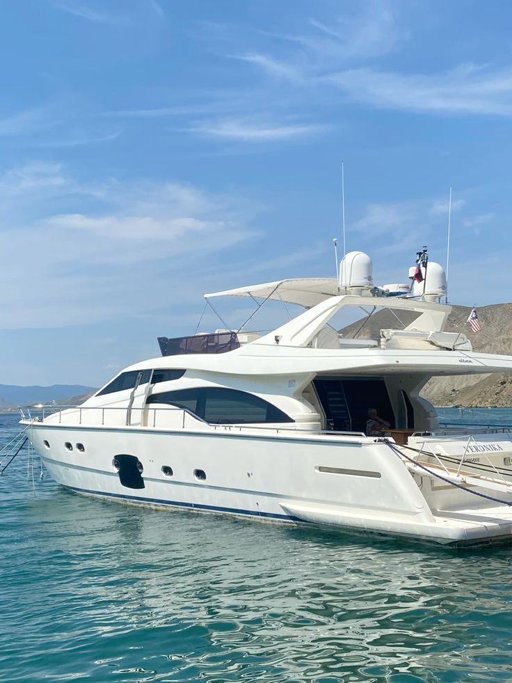 Luxury cabin interior — rich tan leather seating, polished teak flooring, premium yacht finish