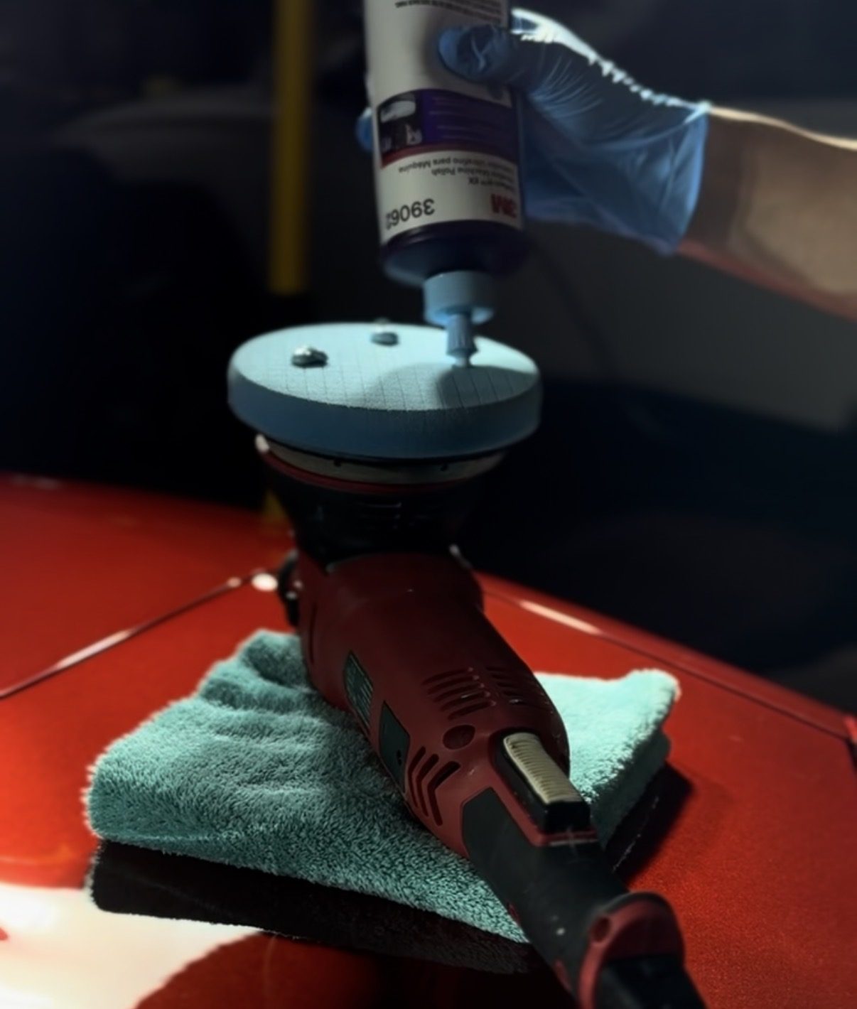 Graphene polish being dispensed onto a dual-action machine polisher — advanced ceramic coating application